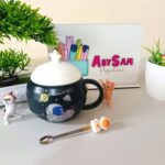 Taza de cerámica con cuchara con aplique astronauta